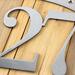 Close up of raw steel on our oval 3 digit metal house number sign.
