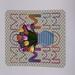 Green polka dot card featuring blue vase of tulips with the words MOM spelled out in rainbow colors over the design