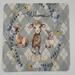 Baby shower card with plaid background featuring baby animals surrounded by blue and yellow flowers and crosses adorned in iridescent paint