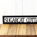 Close up of our hanging rectangular personalized lake house metal wall decor, in matte black powder coat.