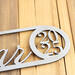 Close up of raw steel on our newborn baby boy or girl name and birthday metal sign.