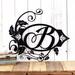 Metal monogram plaque with vines surrounding the letter, B, in matte black powder coat.