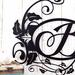 Close up of vines and fleur de lis on our monogram metal sign, in matte black powder coat.