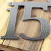 Close up of silver vein powder coat on our airplane house number sign.