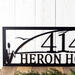 Close up of our custom metal address sign with cattails and a great blue heron, in matte black powder coat.