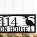 Close up of our custom metal address sign with great blue heron and sunset image, in matte black powder coat.