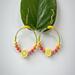 Fun, bright and fresh fruit earrings, with lemon as the focal point and seed beads in yellow, orange, pink and green. Gold plated hook wire.