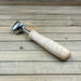 Light colored wood handle coffee scoop