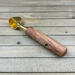 gold and maple wood single serve coffee scoop