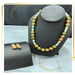 Agate stone with multiple colors. Gold spacers are used between each bead. The necklace is 20 inches long. Included are matching earrings.