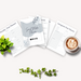 Flat lay of social media planner pages featuring a 'Social Media Planner' cover, alongside a cup of coffee with latte art, and a green plant