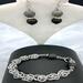 Agate stones of gray and black mixed with chain maille and a rhinestone-encrusted black toggle clasp. 