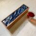 Overview of 5-compartment wooden tea box with ocean waves design.