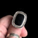 holding on thumb, cushion black onyx gemstone bezel set bead wire and stamped cutout wire accent on tapered wide band