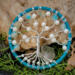 pretty compact wire tree of life wrapped in blue light blue yarn and adorned with pearl beads