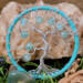 small tree of life made with aluminum wire to create the tree. It is adorned with 8mm light blue glass crackle beads