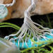 details of aluminum roots twisted into yarn wrapped hoop