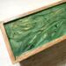 Green and gold design atop this 5-compartments handmade wooden tea box for sorting and displaying  your tea bags for guests. Rich mango wood box with hinged top and a hand-rubbed finish. Perfect for the tea lover.