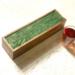 Warm, rich shades of green interspersed with ribbons of metallic gold form a design on top of this tea organizing box that holds up to 50 tea bags.  This tea box is handmade of mango wood with a hinged top and has 5 compartments for organizing your tea bags.  Perfect gift for tea lover or someone who loves to entertain.  Adds a pop of color and luxury to any home decor.