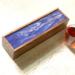 This wood tea organizer has deep purple and white ribbons of acrylic paint  decorating the top with a glossy resin finish.  Inside are 5 compartments for sorting your teas. A great gift for the tea lover or someone who enjoys entertaining.