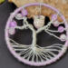 light purple tree displayed against a large chuink of raw crystal