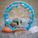 sky blue fluffy yarn wrapped hoop and aluminum wire creates this adorable tree of life. It is adorned with blue beads