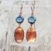 Handmade earrings with blue Czech glass flower beads and hammered copper dangles, romantic artisan jewelry, 1.5 inches long.