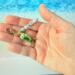 Cute and vibrant personalized fish charm for purses, backpacks, keychains, etc.Green fish charm in hand to show size.
