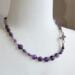 18 in long necklace - amethyst coin and charoite beads, glass tulip beads, and platinum plated cubic zirconia butterfly.