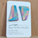 Asymmetrical earrings on card