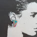Asymmetrical earring shown on picture of woman's head