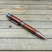 Cowboy boot, western star, and horseshoes on an antique copper ballpoint pen
