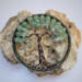celtic style tree of life sits on a large chunk of quartz crystal