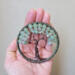 tree is being held in the palm of hand to show accurate sizing
