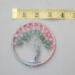 tape measure is used to show 3 inch across metal hoop