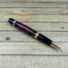 Dark fuchsia and black epoxy resin cast pinecone pen