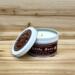 Cool mint and creamy vanilla scented soy candle in 6oz tin with lid off.