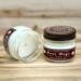 Banana bread scented soy candle in 4oz mason jar. One jar standing up with lid on and one jar on its side with lid off.