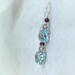 Blue topaz and garnet earrings in sterling silver by MariesGems.