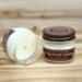 Gingerbread scented soy candle in 4oz jar. One jar standing up with lid on and one jar on its side with lid off.