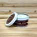 Pumpkin chai scented soy candle in 6oz tin with lid off.