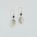 Handmade 2-inch dangle earrings with textured pewter oval drops and small freshwater pearl beads on argentium silver hooks.