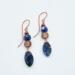 Handmade earrings with faceted sodalite beads and copper wire spirals, 2.5 inches long, ocean-inspired boho jewelry.