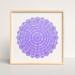 Leaning against a wall and framed in a blond wood, square frame, is the purple, round amulet.