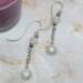 2-inch earrings with platinum sun charms, moonstone beads, and silver ear wires, handcrafted with celestial sparkle