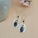 Dangle earrings with sodalite marquise stones and hand-hammered pewter ovals on Argentium silver ear wires.