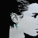 Face profile silhouette wearing a crescent moon earring with star bead