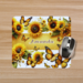 Close up of a personalized sunflowers and yellow butterflies mouse pad with a computer mouse on top. Created by Tammi Oribello Designs.