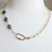 18 inch asymmetrical necklace, gold chain on one side, square blue Czech glass beads on other side, fastened with off-center carabiner clasp
