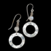 Earrings made with moonstone and silver beads and a pewter washer dangle that has been shaped into a wave pattern
